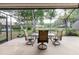 Covered screened-in lanai with tile flooring, ceiling fan, and water view at 4032 Salem Square Ct, Palm Harbor, FL 34685