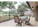 Covered screened-in lanai with tile flooring, ceiling fan, and water view at 4032 Salem Square Ct, Palm Harbor, FL 34685