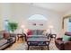 Inviting living room features neutral-toned furniture, vaulted ceiling, and natural light at 4032 Salem Square Ct, Palm Harbor, FL 34685