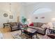 Bright and inviting living room with vaulted ceilings, neutral-toned furniture, and wood flooring at 4032 Salem Square Ct, Palm Harbor, FL 34685