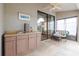 View of screened-in patio with ceiling fan, wicker furniture, wet bar, and outdoor view at 4032 Salem Square Ct, Palm Harbor, FL 34685
