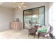 View of screened-in patio with ceiling fan, wicker furniture, wet bar, and outdoor view at 4032 Salem Square Ct, Palm Harbor, FL 34685