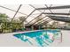 Community pool shows ample seating, attached pool house and clear water at 4032 Salem Square Ct, Palm Harbor, FL 34685
