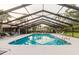 Community pool with ample seating and sunning space, and covered top at 4032 Salem Square Ct, Palm Harbor, FL 34685