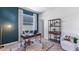 Comfortable home office featuring a stylish desk, a bookshelf, and a cozy chair on a patterned rug at 4035 Westwood Fields Loop, Plant City, FL 33565