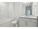 Bright bathroom with tub, modern vanity, and large mirror at 4210 Goldfoil Rd, Spring Hill, FL 34609