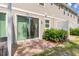 Charming back patio with brick pavers, a small garden, and a sliding glass door for easy indoor-outdoor living at 4316 Sailplane Ct, Wesley Chapel, FL 33545