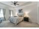 Inviting bedroom featuring a tray ceiling, plush carpet, and soft, neutral decor for a relaxing atmosphere at 4316 Sailplane Ct, Wesley Chapel, FL 33545