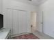 Bedroom featuring carpeting, a closet, and access to another room at 4316 Sailplane Ct, Wesley Chapel, FL 33545