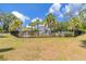A beautiful fenced community pool surrounded by manicured lawns and mature palm trees at 4316 Sailplane Ct, Wesley Chapel, FL 33545