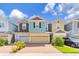 Charming multi-colored townhome featuring a brick driveway, attached garages, and well-maintained landscaping at 4316 Sailplane Ct, Wesley Chapel, FL 33545