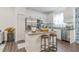 Bright kitchen with white cabinetry, granite countertops, stainless steel appliances, and a convenient breakfast bar at 4316 Sailplane Ct, Wesley Chapel, FL 33545