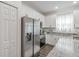 Well-lit kitchen showcasing granite counters, stainless steel appliances, and ample white cabinets at 4316 Sailplane Ct, Wesley Chapel, FL 33545
