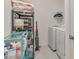 Well-organized laundry area with modern washer and dryer, plus ample storage for cleaning and laundry supplies at 4316 Sailplane Ct, Wesley Chapel, FL 33545