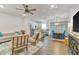Open concept living room featuring modern decor, hardwood floors, and seamless transition to the kitchen at 4316 Sailplane Ct, Wesley Chapel, FL 33545