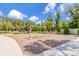 Swing set in the community playground with mature trees and a wood chip surface for safety at 4316 Sailplane Ct, Wesley Chapel, FL 33545