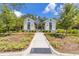 Community pool entrance featuring two buildings with a shaded pergola walkway and black metal fencing at 4316 Sailplane Ct, Wesley Chapel, FL 33545