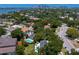 Aerial view featuring a mix of houses, swimming pools, mature trees, and lush landscaping at 444 W Davis Blvd, Tampa, FL 33606