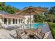 Inviting backyard oasis with a swimming pool, lounge chairs and an outdoor seating area, perfect for entertaining at 444 W Davis Blvd, Tampa, FL 33606