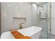 Luxurious bathroom with a soaking tub and sleek glass-enclosed shower at 444 W Davis Blvd, Tampa, FL 33606
