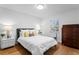 Bright bedroom with hardwood floors and a cozy bed with accent pillows at 444 W Davis Blvd, Tampa, FL 33606