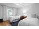 Bright bedroom with twin beds, hardwood floors, and natural light at 444 W Davis Blvd, Tampa, FL 33606
