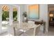 Bright dining area with marble table, modern chairs, and french doors leading to patio with outside dining at 444 W Davis Blvd, Tampa, FL 33606
