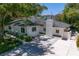 Aerial view of a well maintained home with landscaped front yard, driveway, and mature trees at 444 W Davis Blvd, Tampa, FL 33606