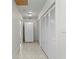 Hallway with a freezer on the left and floor to ceiling storage cabinets on the right at 444 W Davis Blvd, Tampa, FL 33606