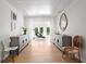 Bright hallway featuring light hardwood floors and elegant decor, leading to an outdoor seating area by the pool at 444 W Davis Blvd, Tampa, FL 33606