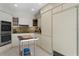 This kitchen features stone counters, white cabinets, tile floor, and stainless steel appliances at 444 W Davis Blvd, Tampa, FL 33606