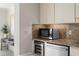 Bright kitchen features granite counters, a stainless steel microwave, a stainless steel dishwasher and a wine cooler at 444 W Davis Blvd, Tampa, FL 33606