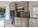 Modern kitchenette featuring stainless steel appliances, sleek cabinetry, and a sink at 444 W Davis Blvd, Tampa, FL 33606