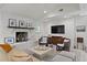 Cozy living room boasts a bright white brick fireplace, and ample seating, with neutral finishes at 444 W Davis Blvd, Tampa, FL 33606