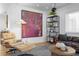 Living room with a colorful art piece, modern shelving, hardwood floors, and comfortable seating at 444 W Davis Blvd, Tampa, FL 33606