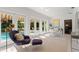 Bright, airy living room with tile floors, modern furniture and doors leading to a pool and patio at 444 W Davis Blvd, Tampa, FL 33606