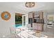 Charming living area with a mini kitchen, pool view, and modern furniture at 444 W Davis Blvd, Tampa, FL 33606