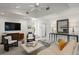 Inviting living room with modern decor, neutral colors, ample seating, and a large TV for entertainment at 444 W Davis Blvd, Tampa, FL 33606