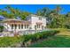 An inviting backyard featuring a sparkling pool, patio furniture, and lush tropical landscaping at 444 W Davis Blvd, Tampa, FL 33606