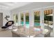 Bright sunroom with a view of the pool area, a round glass dining table, and modern decor at 444 W Davis Blvd, Tampa, FL 33606
