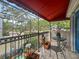 Charming balcony with wrought iron table and chairs overlooking lush backyard at 4941 Bayshore Blvd, Tampa, FL 33611