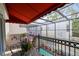 Cozy balcony view with decorative wrought iron railings and a table with chairs under an awning at 4941 Bayshore Blvd, Tampa, FL 33611