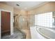 Bathroom with jacuzzi bathtub, shower and glass block wall at 4941 Bayshore Blvd, Tampa, FL 33611