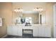 Double sink vanity with large mirror, vanity seating and tiled floor at 4941 Bayshore Blvd, Tampa, FL 33611