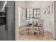 Cozy breakfast nook with a white table and chairs, wainscoting, tile floors, and bright natural light at 4941 Bayshore Blvd, Tampa, FL 33611