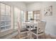 Sunlit breakfast nook with white furniture, tile flooring, wainscoting, and plantation shutters at 4941 Bayshore Blvd, Tampa, FL 33611