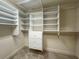 Walk-in closet with white built-in shelving and drawers for organized storage at 4941 Bayshore Blvd, Tampa, FL 33611