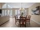 Bright dining room with French doors leading to the pool area and elegant chandelier at 4941 Bayshore Blvd, Tampa, FL 33611