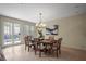 Dining room with a view of the pool, stylish chandelier, and elegant table setting at 4941 Bayshore Blvd, Tampa, FL 33611