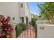 Charming home entrance with an iron gate leading to a paved walkway and lush greenery at 4941 Bayshore Blvd, Tampa, FL 33611
